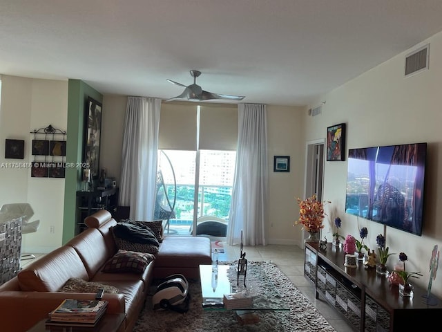 living area featuring visible vents, a ceiling fan, and light tile patterned flooring