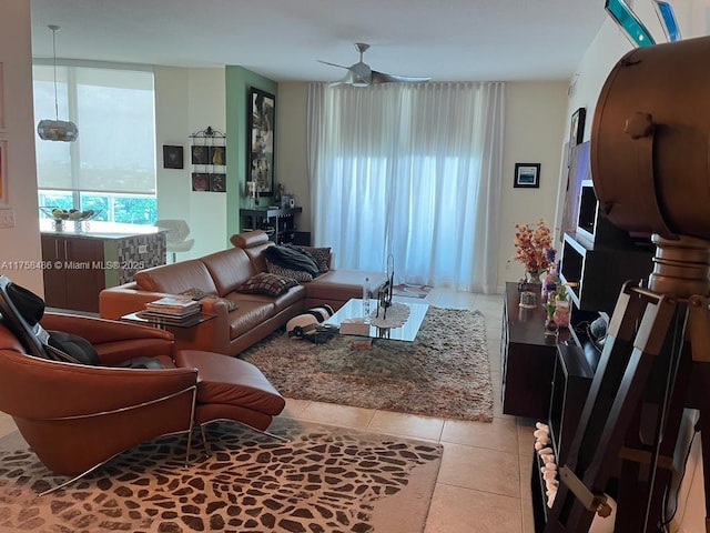 tiled living room with a ceiling fan