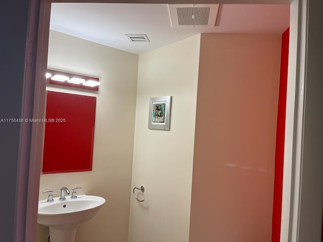 bathroom featuring visible vents and a sink