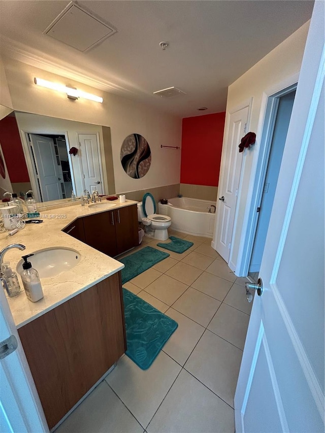 full bathroom with a garden tub, double vanity, a sink, and tile patterned floors