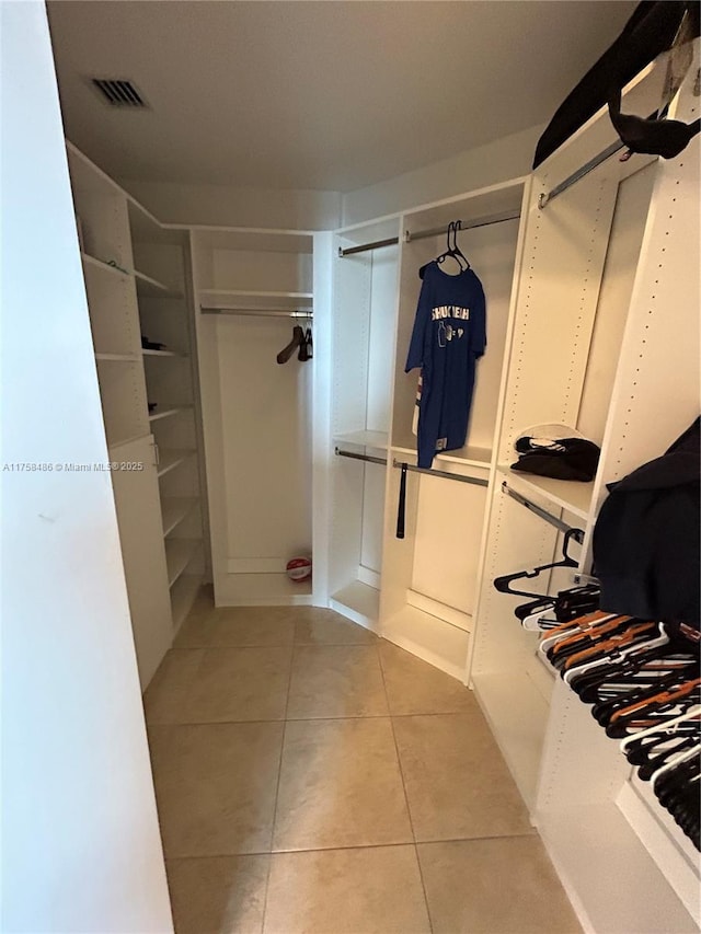 walk in closet featuring tile patterned flooring and visible vents