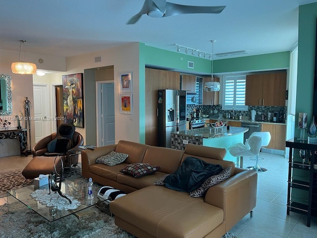 living area with ceiling fan, light tile patterned flooring, and visible vents