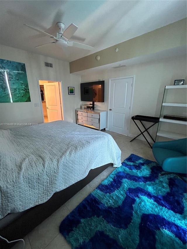 tiled bedroom with lofted ceiling, visible vents, and a ceiling fan