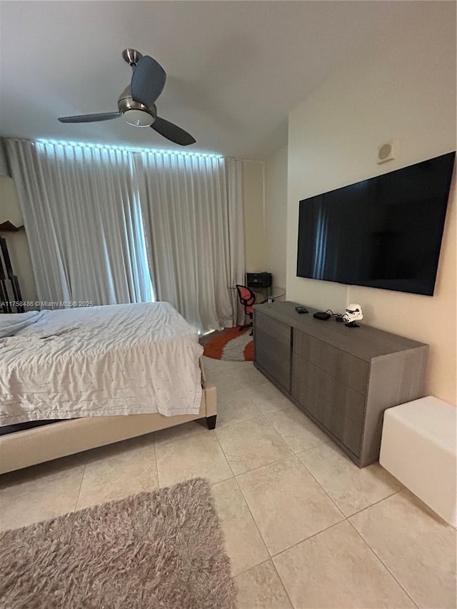 bedroom with ceiling fan and light tile patterned flooring