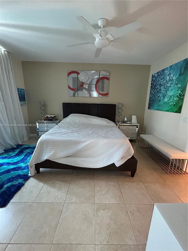 bedroom with a ceiling fan and tile patterned floors