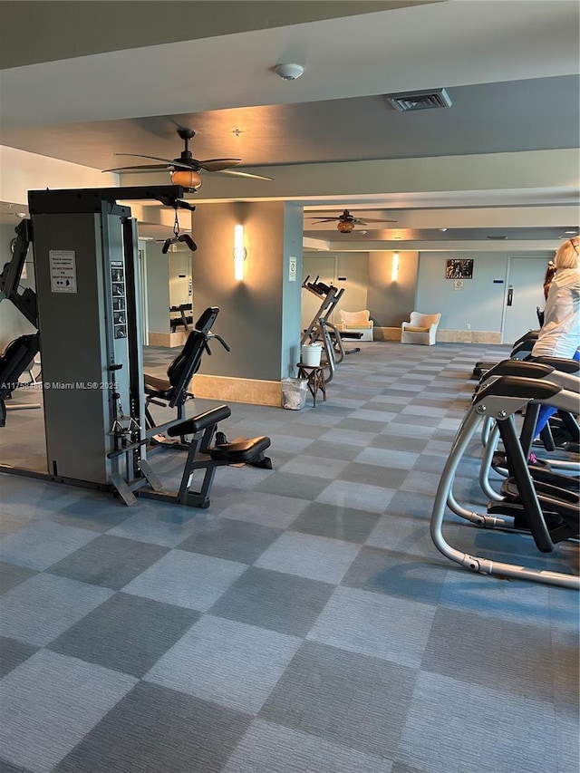 exercise room with carpet floors, baseboards, visible vents, and a ceiling fan