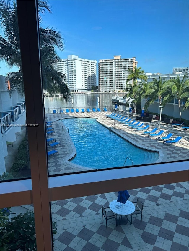 community pool featuring a view of city and a patio