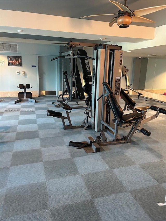 exercise room with carpet, visible vents, and ceiling fan