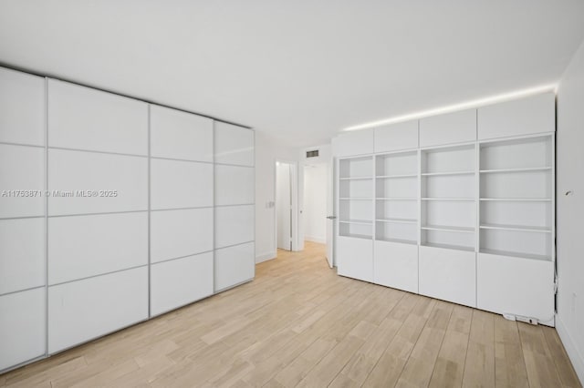 unfurnished bedroom featuring light wood-type flooring and visible vents