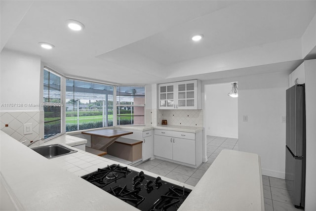 8790 SW 84th St, Miami, FL 33173 - kitchen with glass insert cabinets, freestanding refrigerator, white cabinetry, and decorative backsplash