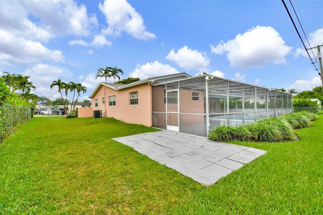 8790 SW 84th St, Miami, FL 33173 - rear view of property with glass enclosure, a patio area, fence, and a yard