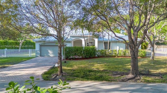 ranch-style house featuring a front lawn, decorative driveway, an attached garage, and stucco siding