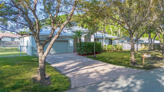 view of front of home featuring fence, a front yard, stucco siding, decorative driveway, and a garage