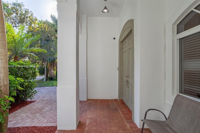 view of exterior entry featuring stucco siding