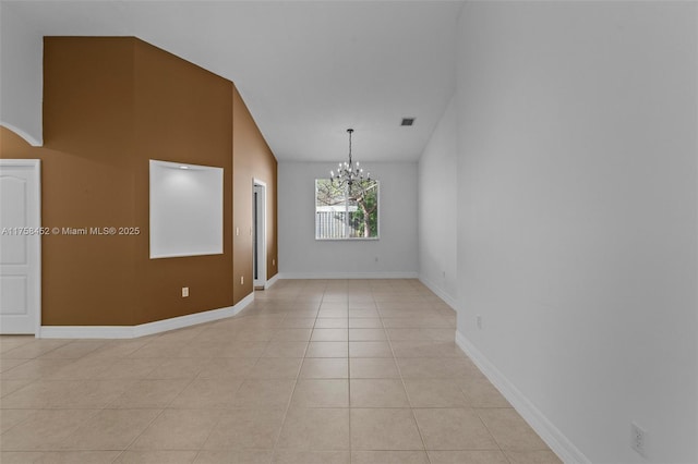 spare room with light tile patterned floors, baseboards, visible vents, an inviting chandelier, and vaulted ceiling