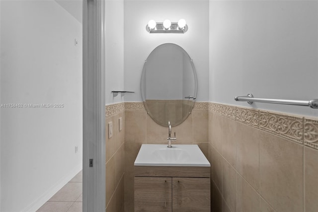 bathroom with tile walls, wainscoting, vanity, and tile patterned flooring