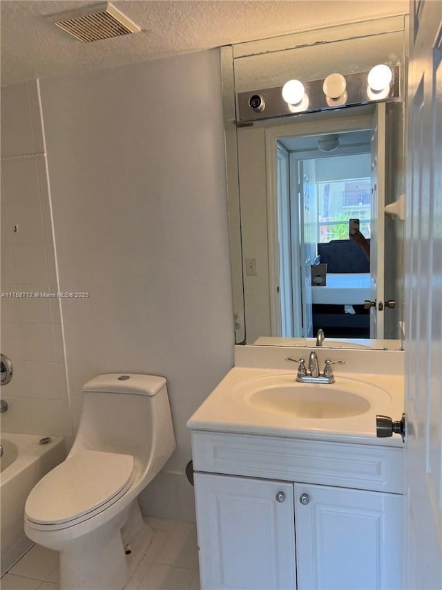 bathroom with visible vents, toilet, a textured ceiling, vanity, and tile patterned floors