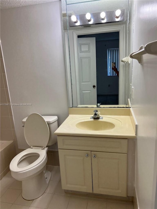 full bath with toilet, tile patterned flooring, a bath, and vanity