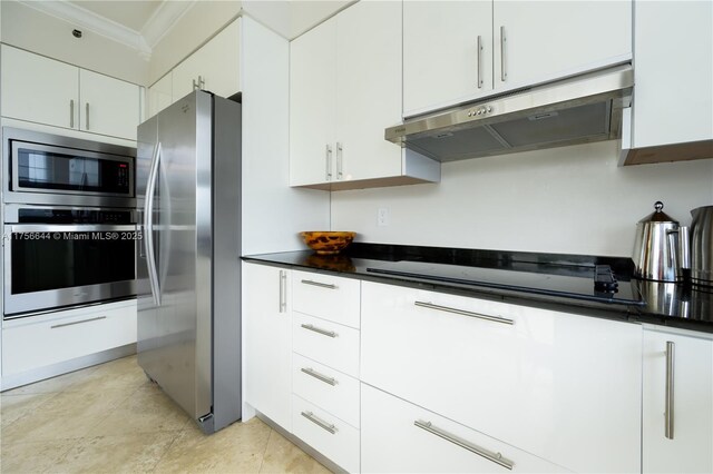 kitchen featuring ornamental molding, white cabinets, appliances with stainless steel finishes, under cabinet range hood, and dark countertops