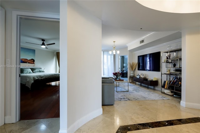 corridor featuring visible vents, baseboards, a notable chandelier, and crown molding