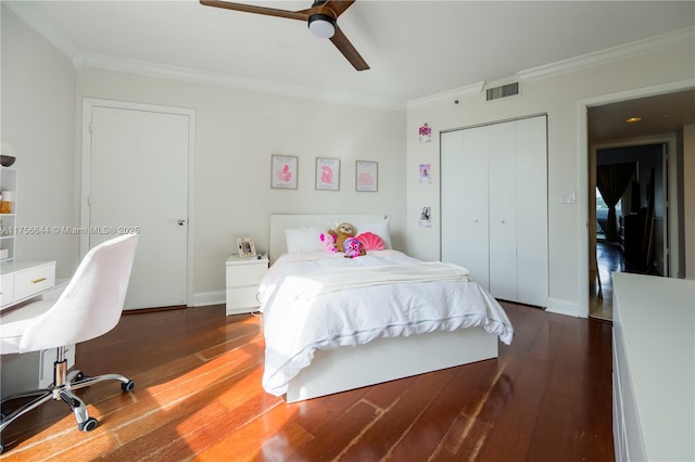 bedroom featuring crown molding, a closet, visible vents, and wood-type flooring