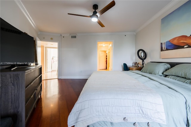 bedroom featuring dark wood-style floors, visible vents, crown molding, and baseboards