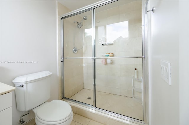 full bathroom featuring a shower stall, toilet, and vanity