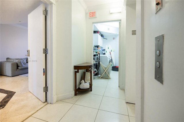 hall with light tile patterned floors and ornamental molding