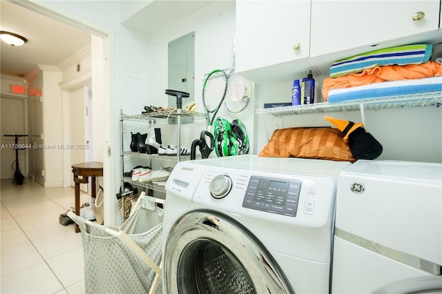 laundry area featuring tile patterned flooring, ornamental molding, electric panel, cabinet space, and independent washer and dryer