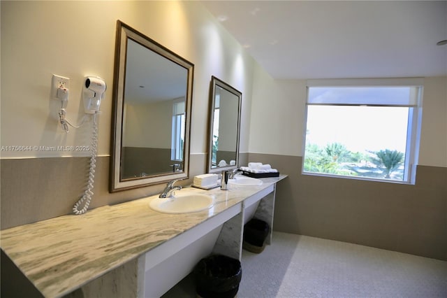 full bath with double vanity and a sink