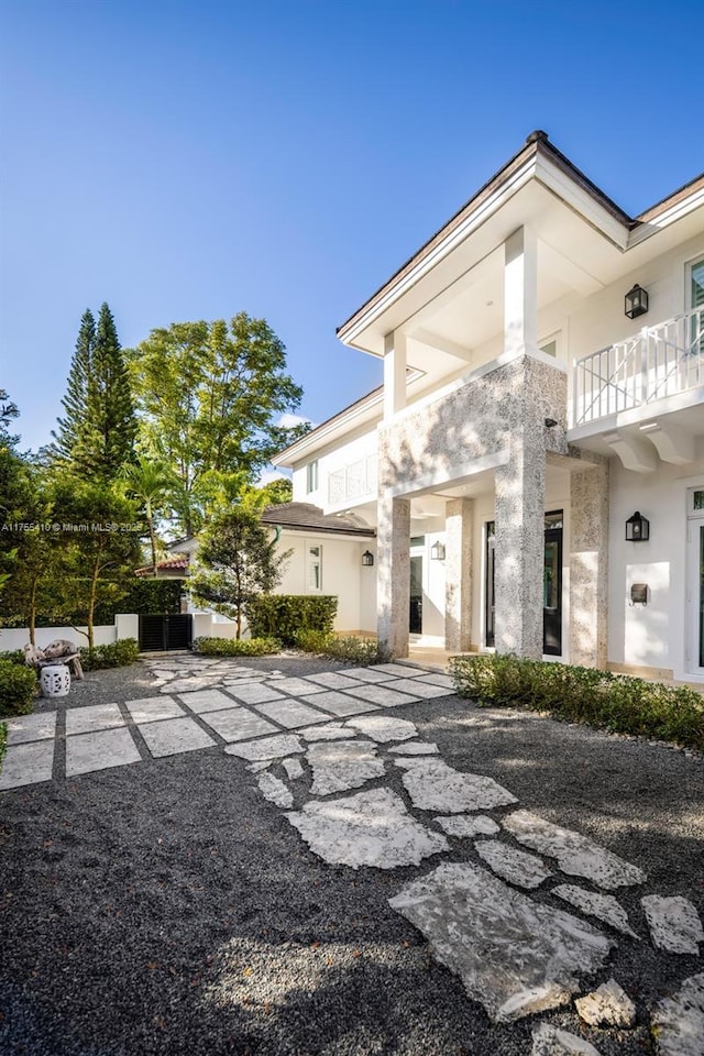 doorway to property with a balcony and stucco siding