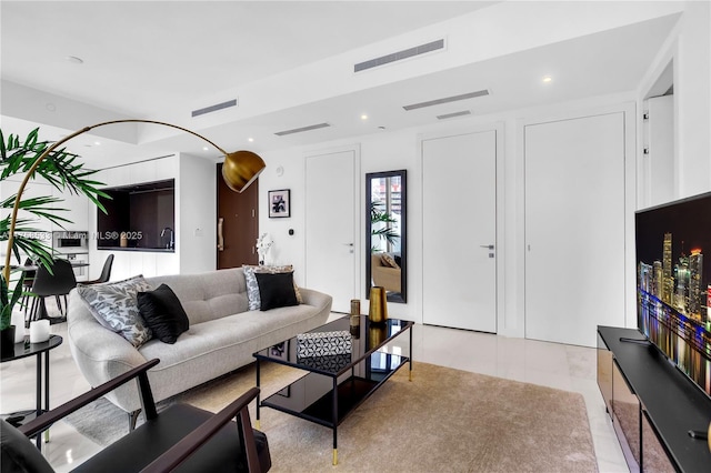 living room with recessed lighting, visible vents, and light tile patterned floors