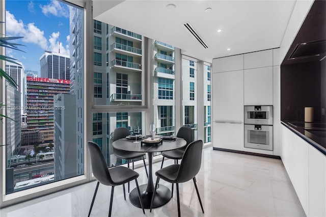 dining space with expansive windows, plenty of natural light, a view of city, and recessed lighting