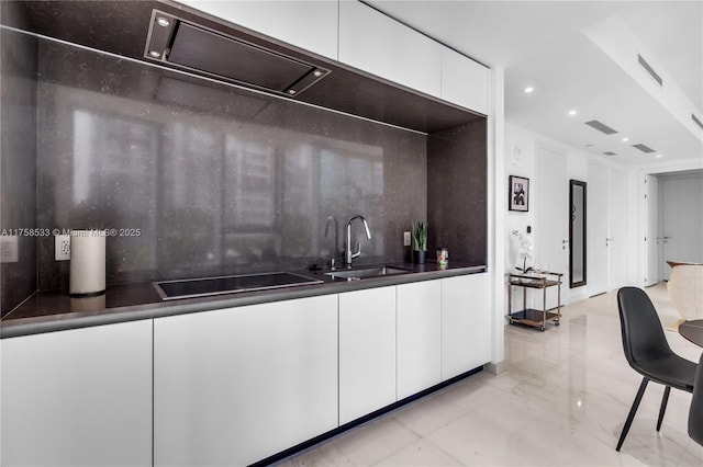 kitchen with tasteful backsplash, visible vents, black electric stovetop, and white cabinetry