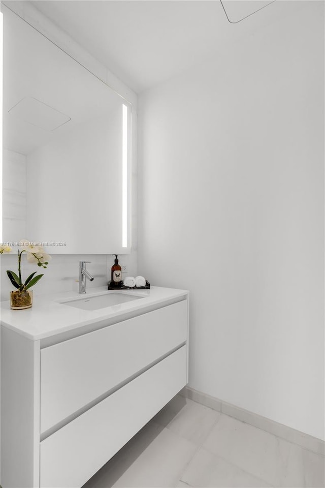 bathroom featuring vanity and baseboards