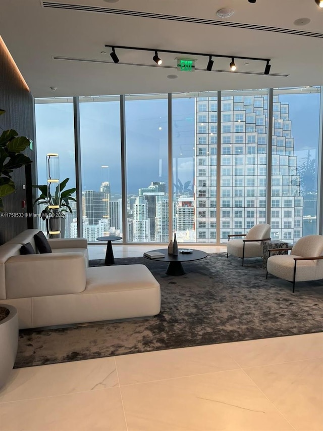 living area with a view of city, floor to ceiling windows, and a wealth of natural light