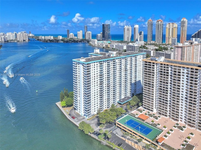 birds eye view of property featuring a city view and a water view