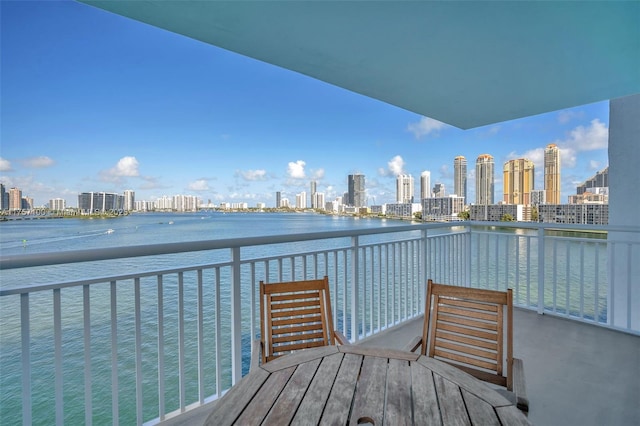 balcony featuring a view of city and a water view