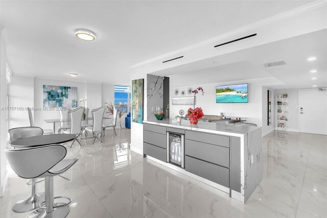 kitchen with wine cooler, marble finish floor, visible vents, gray cabinetry, and modern cabinets