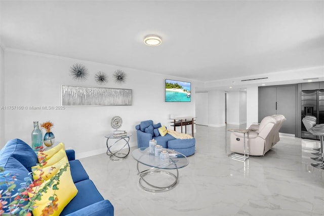 living room featuring ornamental molding, marble finish floor, and baseboards