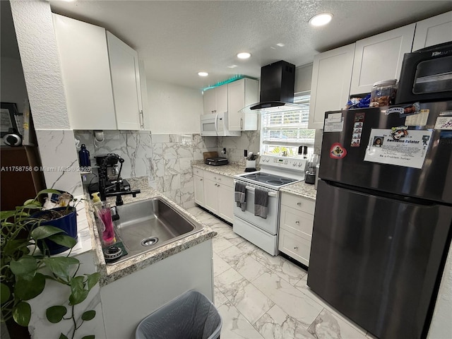 kitchen with a sink, wall chimney range hood, white appliances, a textured ceiling, and marble finish floor