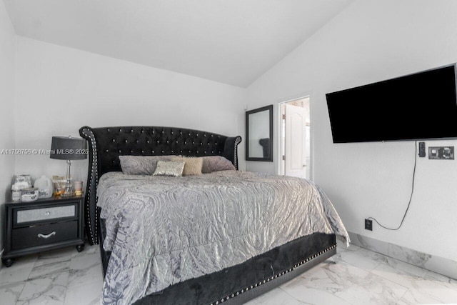 bedroom with marble finish floor, vaulted ceiling, and baseboards