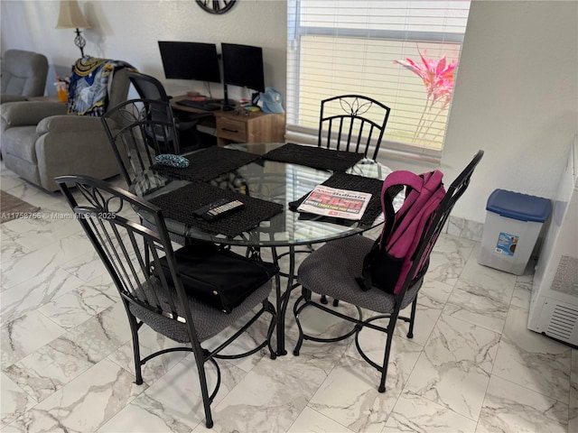 dining room featuring marble finish floor