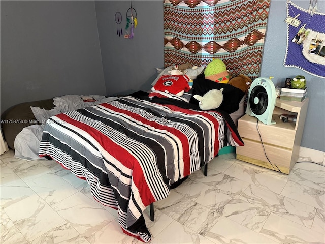 bedroom featuring marble finish floor