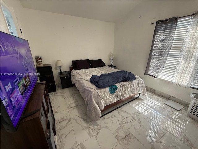 bedroom featuring marble finish floor
