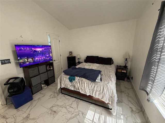 bedroom featuring baseboards, marble finish floor, and lofted ceiling