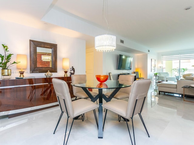 dining room featuring visible vents and a notable chandelier