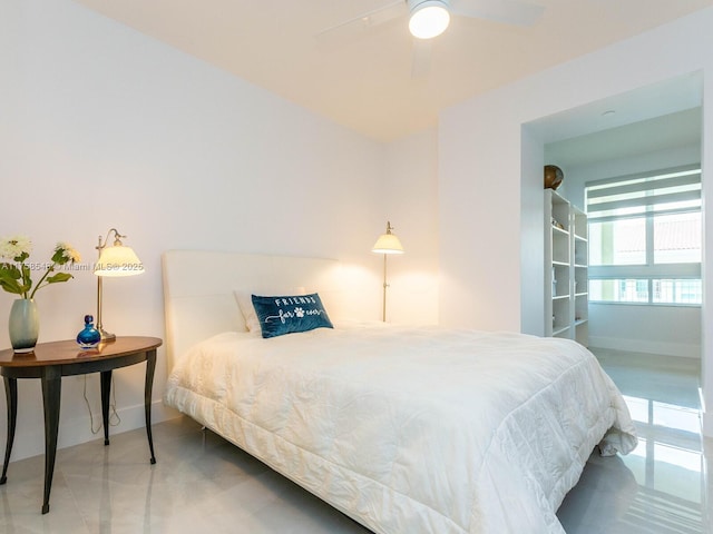 bedroom with ceiling fan and baseboards