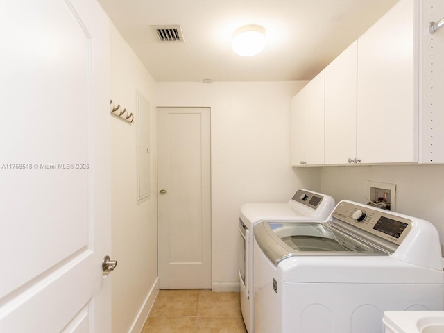 laundry area with cabinet space, visible vents, light tile patterned flooring, independent washer and dryer, and baseboards