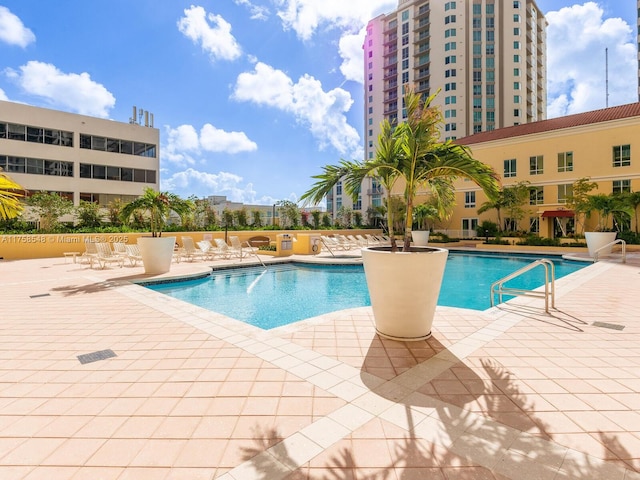 community pool with a patio area